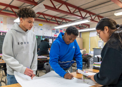 Students in a classroom collaborate on a project.