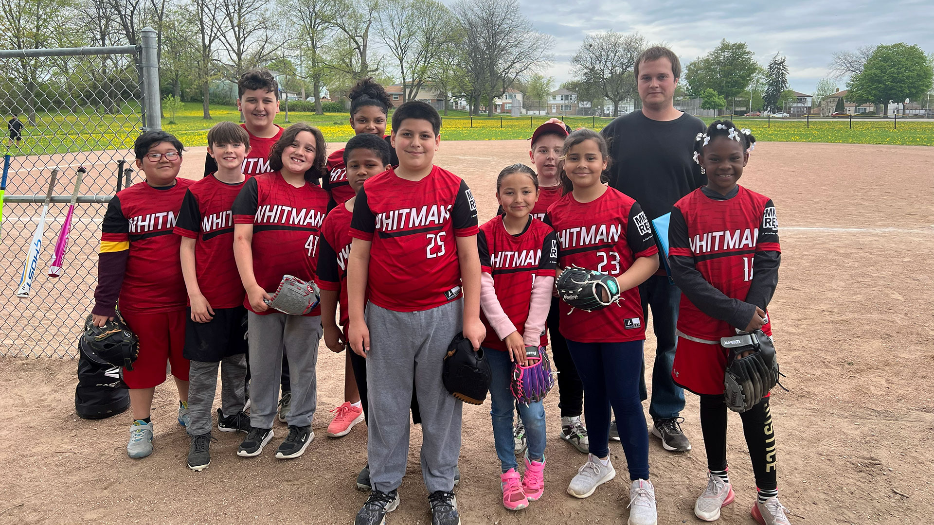 A young baseball team on the sideline.