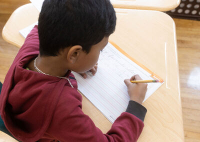 Overhead view of a boy practicing cursive.